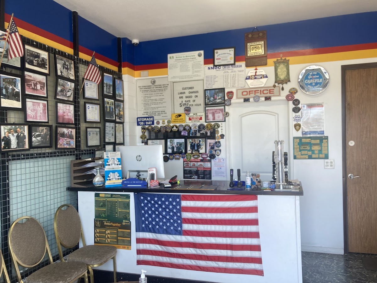 Wall of certifications and awards inside John's Auto Repair
