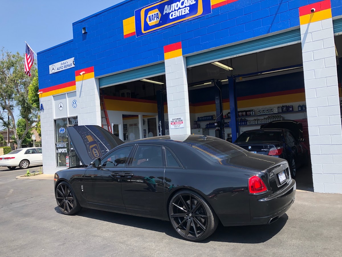 A Rolls-Royce being serviced in the bay at John's Auto Repair
